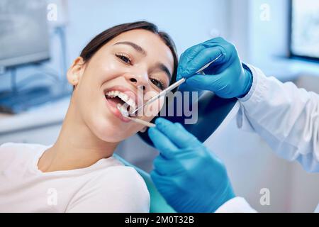 Apritemi a tutto campo. una giovane donna che ottiene la sua bocca controllata dal suo dentista. Foto Stock