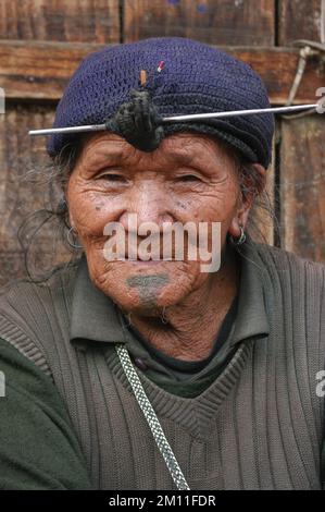 Ziro, Arunachal Pradesh, India - 03 04 2014 : Ritratto del vecchio Apatani tribale con tatuaggio tradizionale del mento e mordente frontale dei capelli con ago Foto Stock