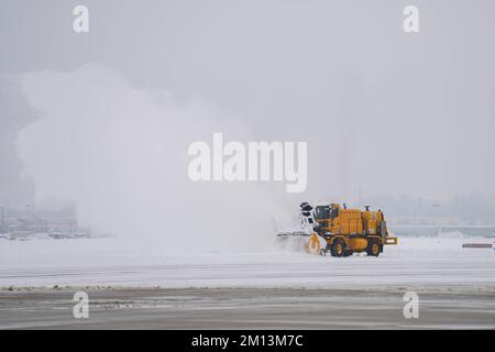 114th il team addetto alla rimozione della neve di Fighter Wing lavora sodo presso Joe Foss Field, S.D. dopo la tempesta invernale il 9 dicembre 2022. I militari si offrono volontari per questo ulteriore dovere per assicurare che la missione sia compiuta. (STATI UNITI Air National Guard Photo di Master Sgt. Duane Duimstra/rilasciato) Foto Stock