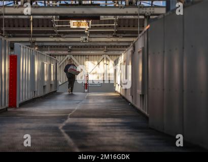 Passeggeri della Lone Railway che attraversano la passerella alla stazione ferroviaria di Crewe Foto Stock