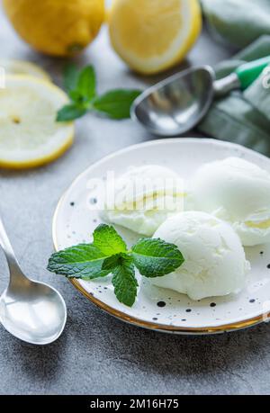 Gelato artigianale al limone di agrumi con menta sul piatto Foto Stock