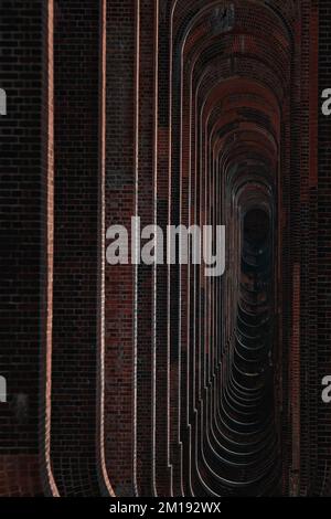 Un colpo verticale di pareti di mattoni di forma ovale, fresco per lo sfondo Foto Stock
