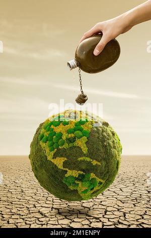 Un uomo versa l'acqua da un pallone sul pianeta verde Terra nel deserto. Simbolo della siccità e della scarsità d'acqua Foto Stock
