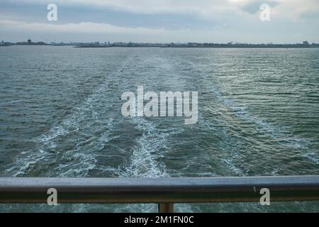 una nave da crociera che lascia il porto visto dalla ringhiera Foto Stock