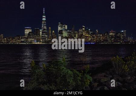 Skyline di New York di notte dalla costa del New Jersey con le luci della città Foto Stock