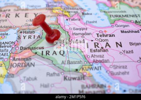 Puntino rosso che indica la posizione di Baghdad primo piano della mappa mondiale Guarda la fotografia d'archivio Foto Stock