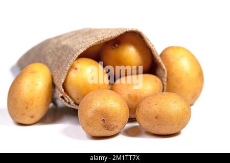 Patate in sacco di iuta isolato su sfondo bianco Foto Stock