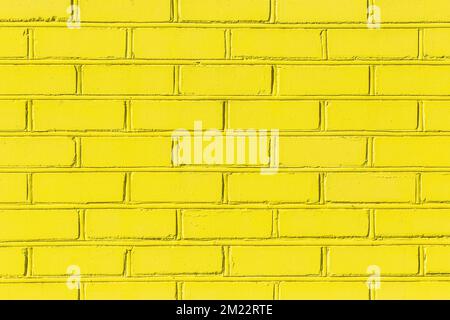 La vernice gialla su un mattone luminoso blocca le pareti urbane texture vivace sfondo. Foto Stock