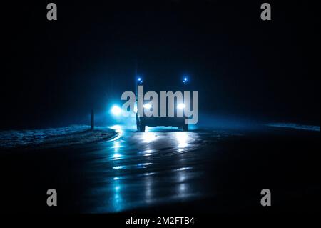 Rottweil, Germany. 14th Dec, 2022. Cars and trucks drive in the morning rush hour on the Bundesstraße 27 (B27) near Rottweil. The headlights are reflected on the road. Credit: Silas Stein/dpa/Alamy Live News Stock Photo