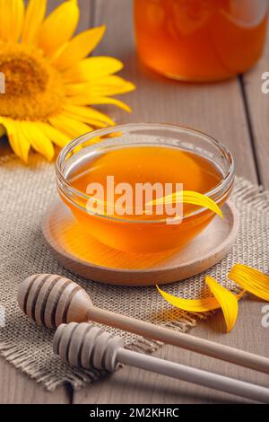 honey in a glass jar on a wooden table Stock Photo