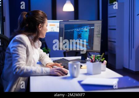 Redattore che sviluppa un nuovo progetto di film, montaggio di video audio montaggio seduto in ufficio di produzione a tarda notte. Creator di contenuti creativi utilizzando computer professionali, tecnologia moderna, rete wireless Foto Stock