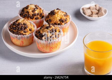 Fresh chocolate muffin and orange juice Stock Photo