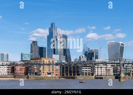 A view across the Thames of the office blocks and the on going construction work in the City of London, financial district, as seen from, Bankside Bea Stock Photo