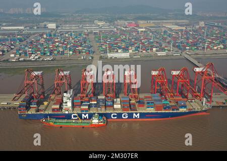 Ningbo. 13th Dec, 2022. This aerial photo taken on Dec. 13, 2022 shows a cargo ship docking at Ningbo-Zhoushan Port in east China's Zhejiang Province. The cargo and container throughput of Ningbo-Zhoushan Port registered year-on-year growth of 3.41 percent and 7.84 percent respectively in the first 11 months in 2022. The port saw its cargo throughput reach 1.16 billion tons while the container throughput achieved 31.26 million twenty-foot equivalent units (TEUs). Credit: Huang Zongzhi/Xinhua/Alamy Live News Stock Photo