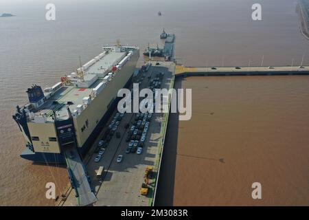 Ningbo. 13th Dec, 2022. This aerial photo taken on Dec. 13, 2022 shows a ro-ro ship docking at Meidong Dock of the Ningbo-Zhoushan Port in east China's Zhejiang Province. The cargo and container throughput of Ningbo-Zhoushan Port registered year-on-year growth of 3.41 percent and 7.84 percent respectively in the first 11 months in 2022. The port saw its cargo throughput reach 1.16 billion tons while the container throughput achieved 31.26 million twenty-foot equivalent units (TEUs). Credit: Huang Zongzhi/Xinhua/Alamy Live News Stock Photo