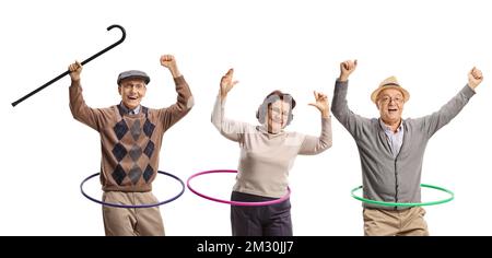 Happy senior people spinning hula hoops isolated on white background Stock Photo