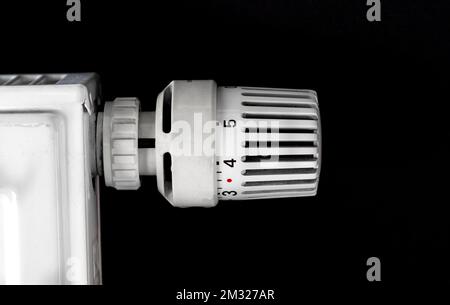 La testa della valvola termostatica del radiatore e il riscaldatore si chiudono, regolando la temperatura, la crisi energetica e aumentando i costi di riscaldamento Foto Stock