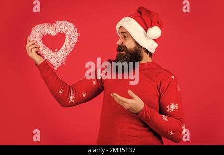 Buon natale e Felice Anno Nuovo. Ragazzo indossare Santa cappello. Innamorati. Ti voglio bene. Permettetemi di sciogliere il vostro cuore. Il Natale nel vostro cuore. Bello Foto Stock