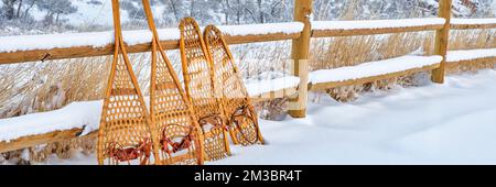 classic wooden snowshoes in winter scenery at foothills of Rocky Mountains in northern Colorado, panoramic web banner Stock Photo