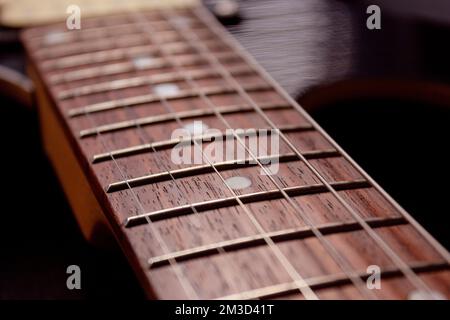 closeup a sei corde di chitarra elettrica e fretboard di legno . Concetto di strumenti e musica Foto Stock