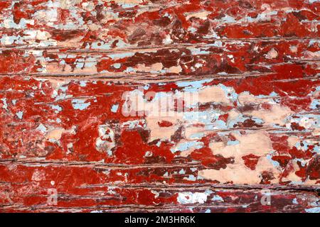 Defocus vecchio legno rosso texture stressato grunge fondo, graffiato bianco vernice su tavole di legno muro. Fuori fuoco. Foto Stock