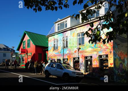 Gli edifici colorati e la gente sulla strada in una giornata di sole a Reykjavik, Islanda Foto Stock