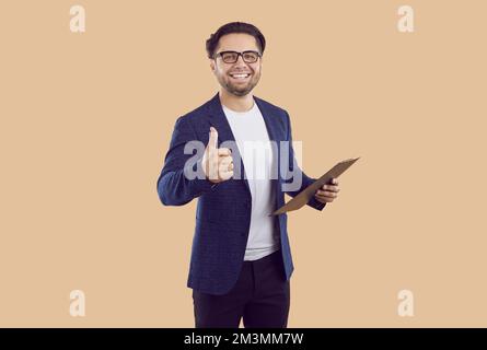 Agente di affari o responsabile di vendite riuscito con gli appunti che mostrano i pollici in su e sorridente Foto Stock