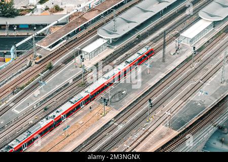 piattaforma ferroviaria con passeggeri e un moderno treno ad alta velocità in partenza in base all'orario programmato Foto Stock