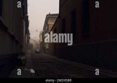 Strada acciottolata stretta in una giornata di nebbia Foto Stock