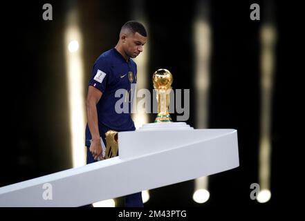 Kylian Mbappe, francese, sembra sconsolato mentre supera il Trofeo della Coppa del mondo FIFA dopo aver subito la sconfitta in Argentina nella finale della Coppa del mondo FIFA allo stadio di Lusail, Qatar. Data immagine: Domenica 18 dicembre 2022. Foto Stock