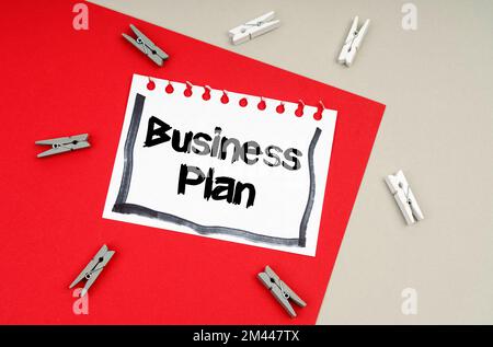 Concetto di business e finanza. Vestiti e un foglio di taccuino con l'iscrizione - Business Plan Foto Stock