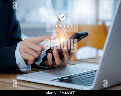 Concetto di autenticazione in due fasi (2FA). Codice delle icone 2023, Shield e asterisco visualizzato sullo smartphone mentre si utilizza il computer per convalidare la password, l'inserimento di dati Foto Stock