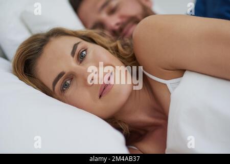 Devo amare quelle sdraie domenicali. una felice coppia di mezza età che si rilassa a letto insieme. Foto Stock