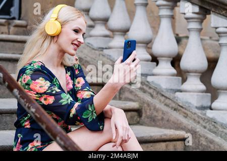 Donna durante una videochiamata per strada Foto Stock