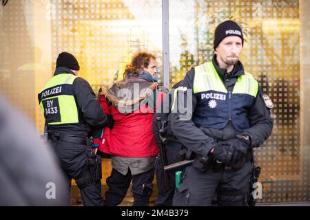 Monaco, Germania. 20th Dec, 2022. Quattro attivisti dell'ultima generazione hanno bloccato la Sonnenstraße a Monaco di Baviera, in Germania, il 20 dicembre 2022, nonostante un ordine del KVR contro i blocchi di colla. In anticipo, l'azione è stata ufficialmente annunciata, che è il motivo per cui un sacco di polizia è stato sul posto e ha fermato altri 6 attivisti prima di poter bloccare la strada. L'ultima generazione dimostra un biglietto da 9 euro e un limite di velocità di 100 km/h sulle autostrade. (Foto di Alexander Pohl/Sipa USA) Credit: Sipa USA/Alamy Live News Foto Stock