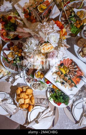 vista dall'alto del tavolo festivo con vari piatti e spuntini. Foto Stock