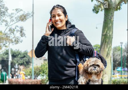 Cattura i momenti più belli. Giovane ragazza in pelliccia e occhiali blu  crea una cornice con le mani, città sullo sfondo Foto stock - Alamy