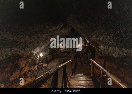 Esplora una grotta vulcanica nel Parco delle grotte vulcaniche ai piedi del vulcano Villarrica a Pucon, Cile Foto Stock