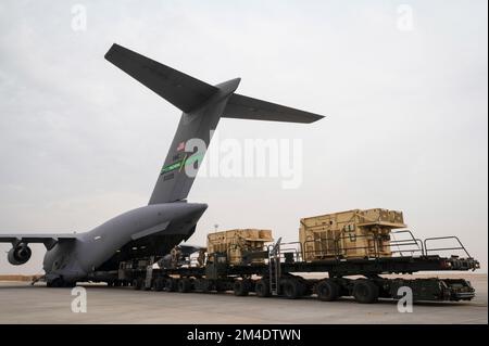 443rd Air Expeditionary Squadron Air Mobility Airmen collega due sintonizzatori 60K per caricare più stazioni di controllo a terra su un C-17 Globemaster III presso la base aerea di al Asad, Iraq, 12 dicembre 2022. Manovrare insieme due sintonizzatori 60K consente di risparmiare tempo durante il caricamento dell'attrezzatura, eliminando il tempo necessario per posizionarli in modo perfetto. (STATI UNITI Air Force foto di staff Sgt. Dalton Williams) Foto Stock