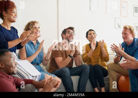 Stanno lasciando questa riunione che si sente ispirata. un gruppo di creativi che si aggrappano le mani in un ufficio moderno. Foto Stock
