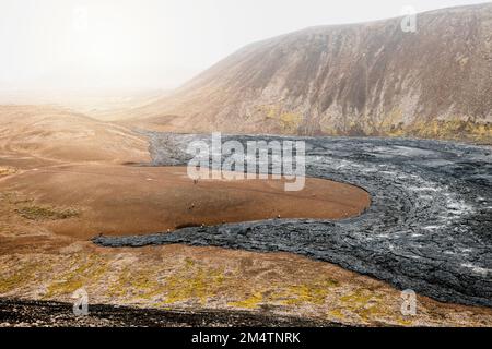 Vista aerea delle rocce laviche vulcaniche nere e del suolo rosso negli altopiani islandesi vicino al vulcano Geldingadalir Foto Stock