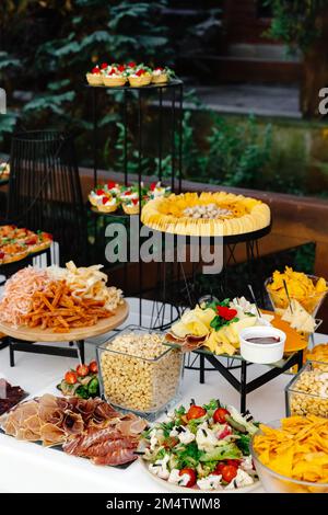 Tavolo a buffet della reception con spuntini freddi, carne e insalate. Foto Stock