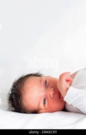 Ragazza cute neonato sdraiata sul letto Foto Stock
