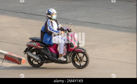 SAMUT PRAKAN, THAILANDIA, 23 2022 FEBBRAIO, Una donna con casco cavalca una moto Foto Stock