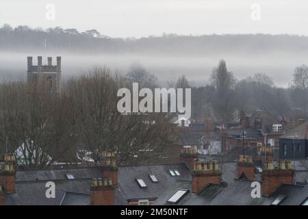 UK Weather, 24 December 2022: La vigilia di Natale a Henley-on-Thames la nebbia di prima mattina dal fiume sorge sopra i tetti della città e la torre quadrata della chiesa di Santa Maria. Con il clima mite e umido in Inghilterra non ci sarà un Natale bianco quest'anno. Anna Watson/Alamy Live News Foto Stock