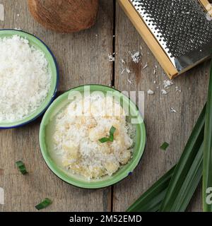 Top View Cassava al vapore con fragrante cocco grattugiato, tradizionale Dessert Tailandese Foto Stock