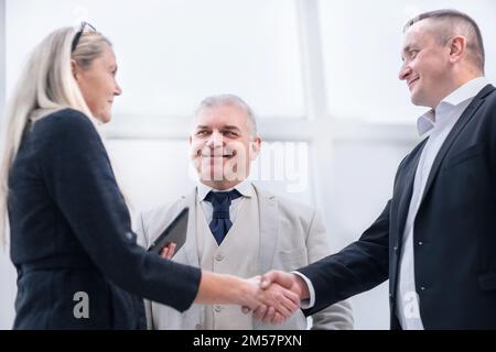 primo piano: sorridendo uomini d'affari che scuotono le mani. Foto Stock