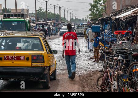 Ragazzo africano locale con camicia da calcio del Manchester United rosso brillante a Bamako, Mali, Africa occidentale. Foto Stock