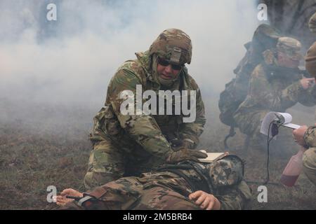 Jeremy Isaacs, un poliziotto militare con quartier generale della forza congiunta, simula la fornitura di una cura tattica di combattimento a un incidente durante il concorso migliore guerriero della Guardia nazionale del Tennessee del 2022 a Lavinia il 24 febbraio. I concorrenti hanno eseguito i compiti di Army Warrior e sono stati segnati sulla velocità e competenza. Foto Stock