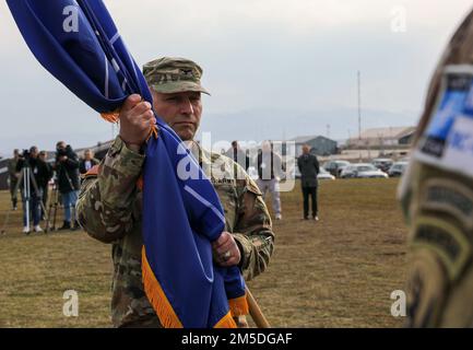 Campo BONDSTEEL, Kosovo – col. Christopher Samulski, comandante, 116th squadra di combattimento della Brigata di Fanteria, Guardia Nazionale della Virginia, e il comando regionale della forza del Kosovo - comandante Est, detiene la bandiera della NATO durante la cerimonia di trasferimento dell'autorità della KFOR RC-Est a Camp Bondsteel, Kosovo, 4 marzo 2022. La 86th IBCT, Vermont National Guard ha ceduto la responsabilità della KFOR RC-East alla 116th IBCT durante la cerimonia di trasferimento dell'autorità. Foto Stock